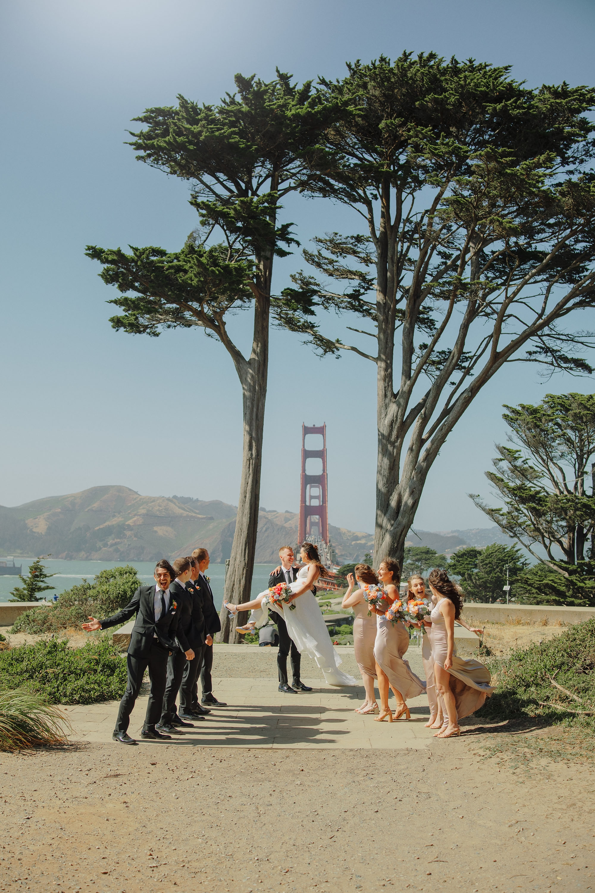 bride and groom with their bridal party at Golden Gate Overlook and Golden Gate Bridge in background
